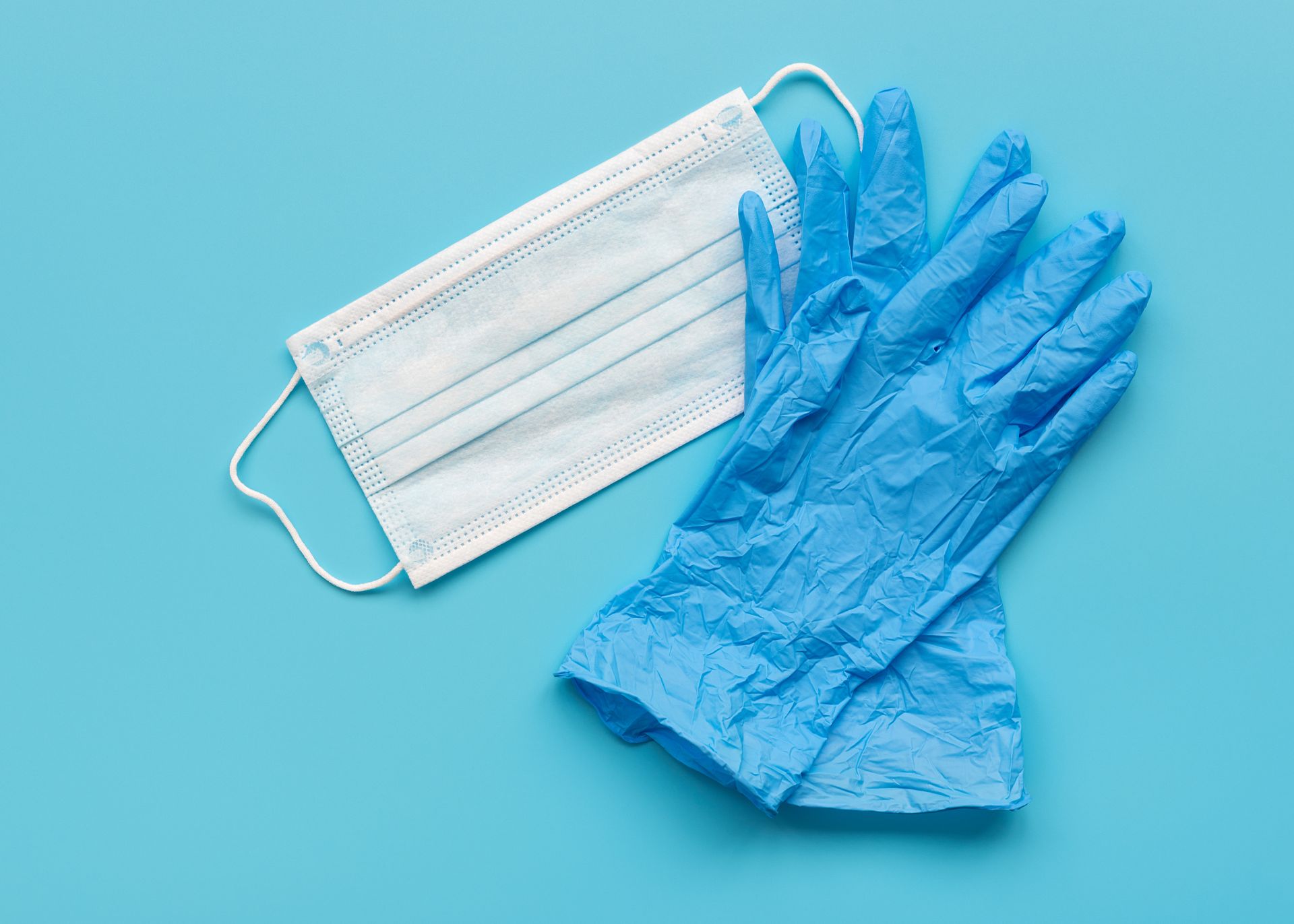 Blue medical gloves and surgical mask to illustrate use for administering Narcan to small dogs