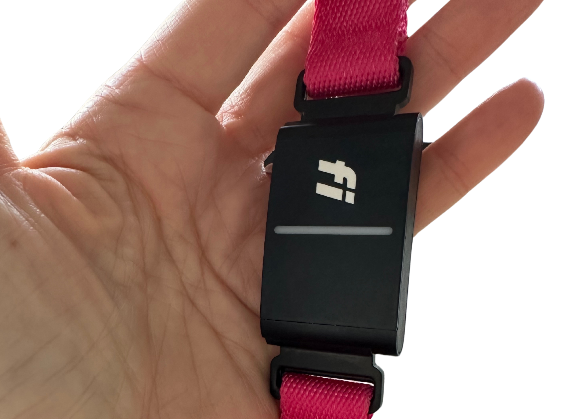 Close up of Fi GPS device on pink collar being held on human palm