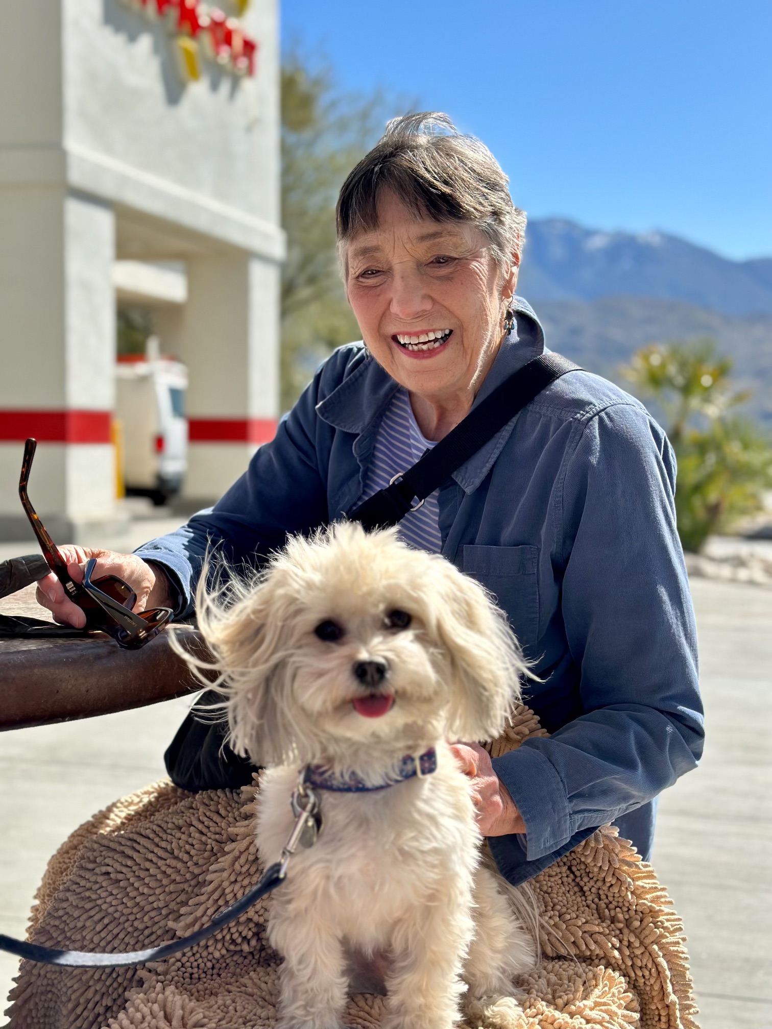 Smiling older woman with white dog