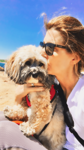 Woman kissing small dog