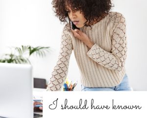 Woman on phone looking concerned and looking up information on computer