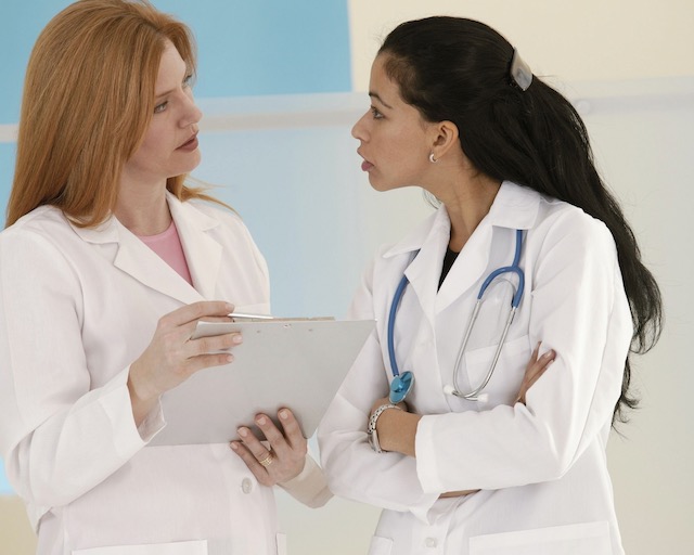 Two doctors strongly discussing a file