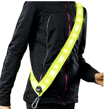 Neon yellow reflective sash on jacketed person. Shows torso only